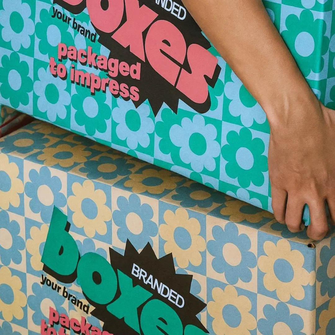 Hands holding floral boxes